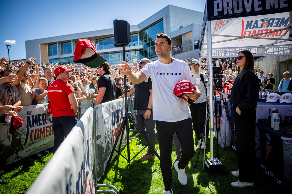 FILE - Charlie Kirk hands out hats before speaking at Utah Valley University in Orem, Utah, Sept. 10, 2025. (Tess Crowley/The Deseret News via AP, File)