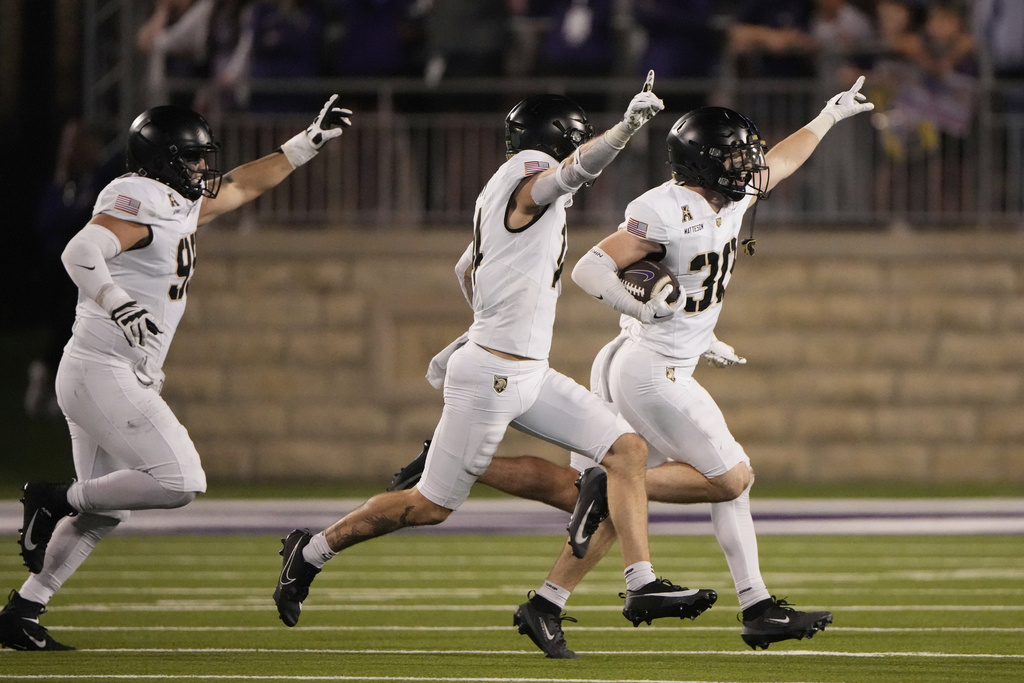 Army safety Collin Matteson (30) celebrates with teammates after intercepting a pass late in the second half of an NCAA college football game against Kansas State, Saturday, Sept. 6, 2025, in Manhattan, Kan. (AP Photo/Charlie Riedel)