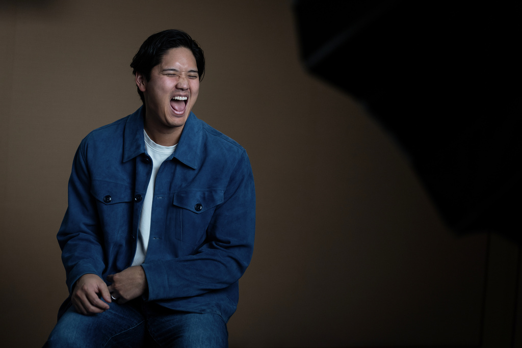 Los Angeles Dodgers' Shohei Ohtani shares a laugh with his translator during an interview with The Associated Press in Pasadena, Calif., Wednesday, Nov. 26, 2025. (AP Photo/Jae C. Hong)