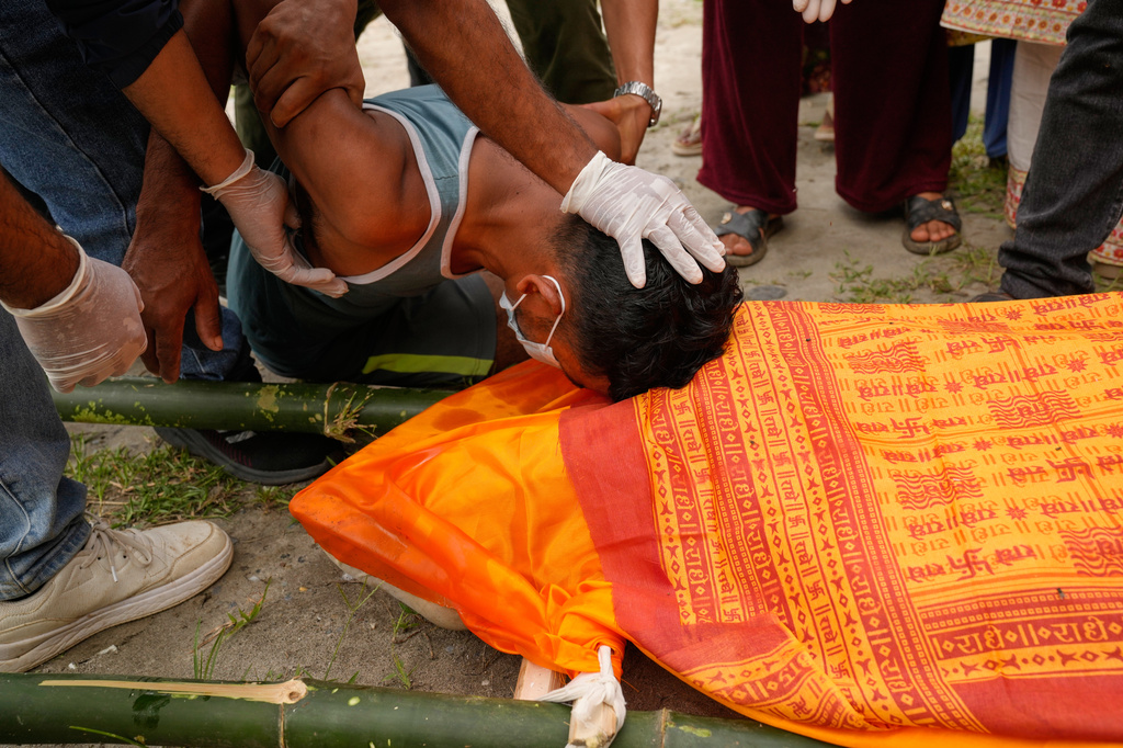 Krishna Khadka, father of Aayush Khada, who was killed in flash floods breaks down during his son's cremation, in Chitwan, Nepal, Monday, Aug. 31, 2026. (AP Photo/Dar Yasin)