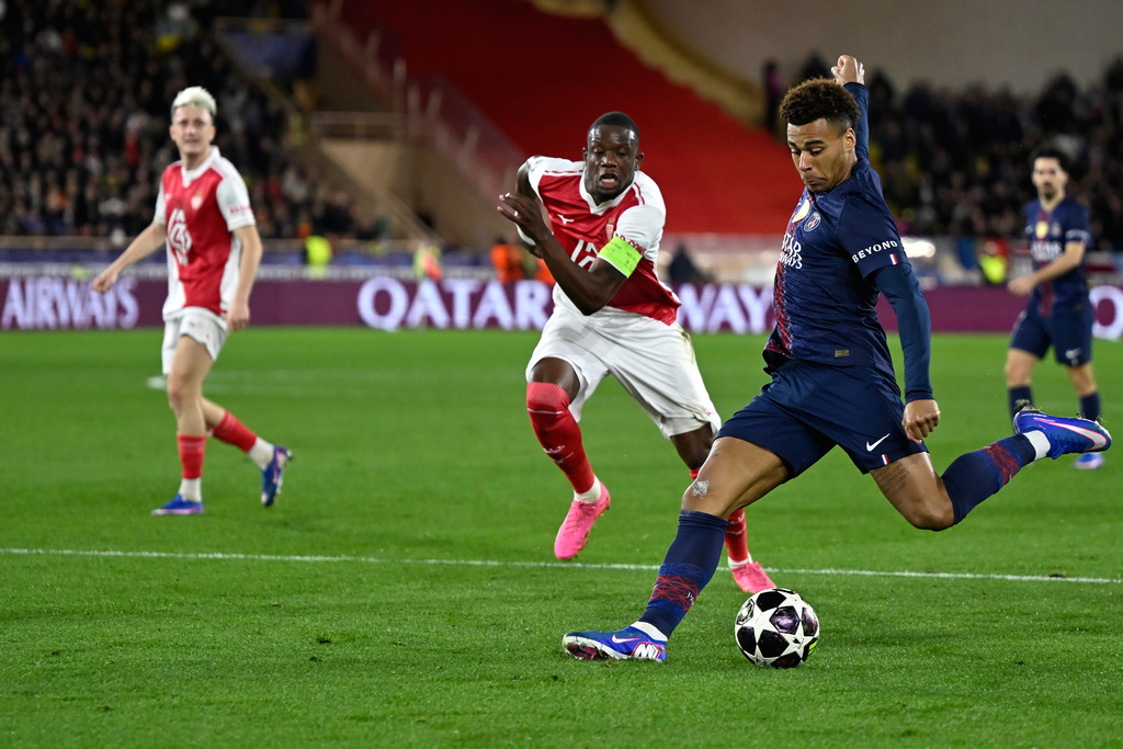 PSG's Desire Doue scores his side's opening goal during the first-leg of the Champions League playoff soccer match between Monaco and Paris Saint-Germain in Monaco, Tuesday, Feb. 17, 2026. (AP Photo/Philippe Magoni)
