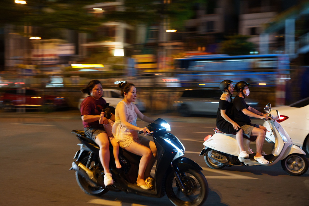 CORRECTS TO CALL THE AREA THE OLD QUARTER - Vietnamese ride two-wheelers in the Old Quarter area in Hanoi, Vietnam, on Aug. 31, 2025. (AP Photo/Vincent Thian)