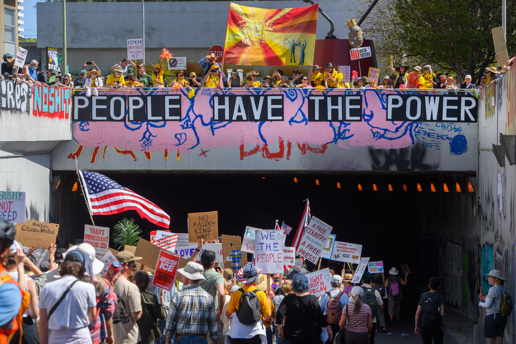 Demonstrators march during the "No Kings" protest in Oakland, Calif., on Saturday, March 28, 2026. (Jose Carlos Fajardo/Bay Area News Group via AP)