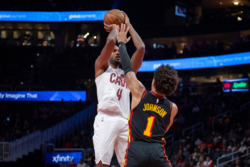 Cleveland Cavaliers center Evan Mobley (4), left, attempts a basket against Atlanta Hawks forward Jalen Johnson (1), right, during the first half of an NBA Cup basketball game, Friday, Nov. 28, 2025, in Atlanta. (AP Photo/Erik Rank)
