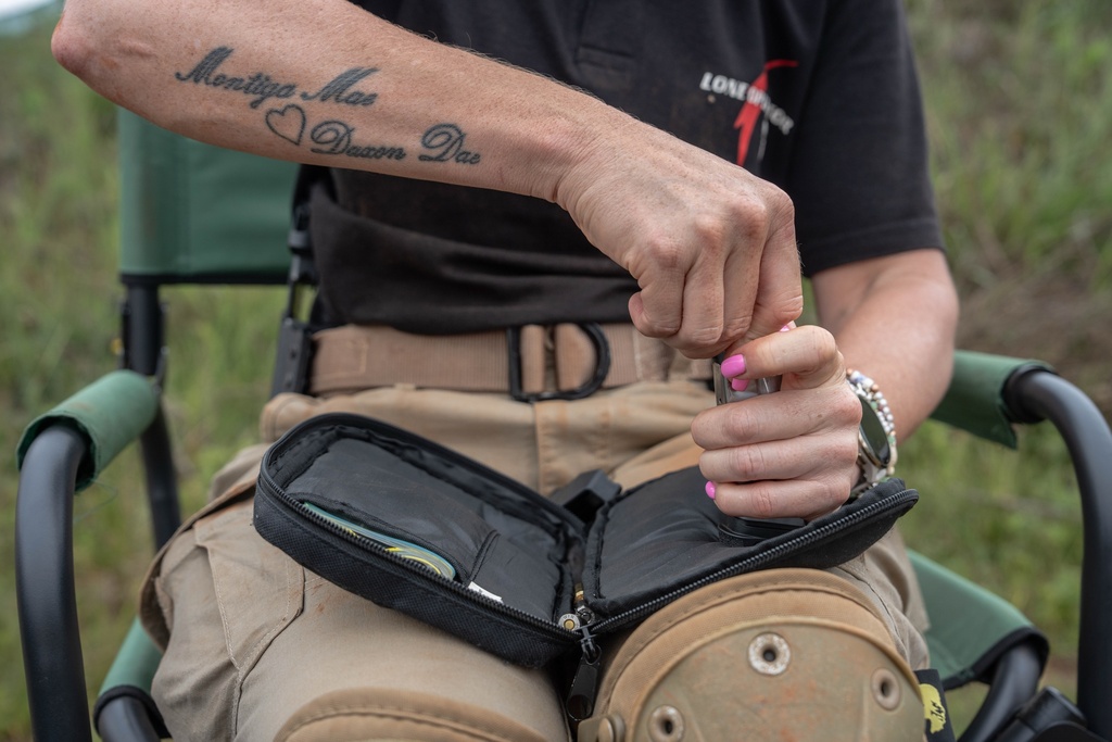 A female student reloads her magazine after a round of shooting at the Out There Sport Shooting Range in Bronkhorstspruit, Pretoria, South Africa, Saturday, Jan. 24, 2026. (AP Photo/Jacques Nelles)