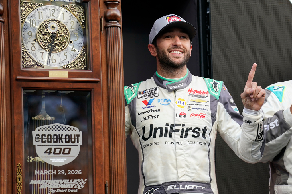 Chase Elliott poses with the trophy in Victory Lane after winning a NASCAR Cup Series auto race in Martinsville, Va., Sunday, March 29, 2026. (AP Photo/Chuck Burton)