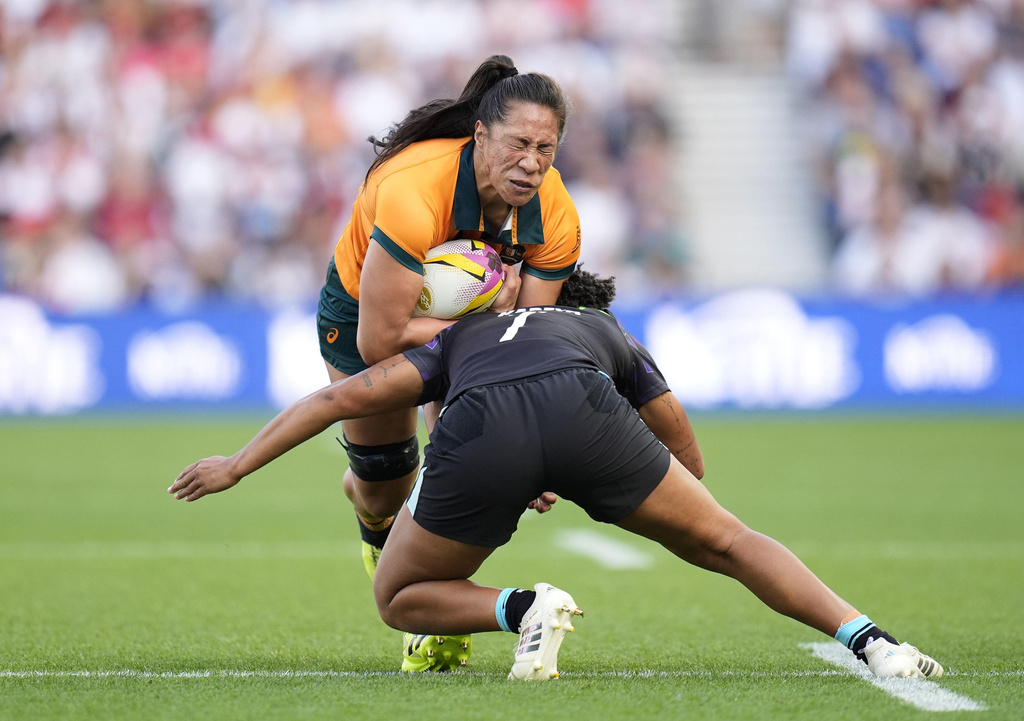 England's Sadia Kabeya tackles Australia's Siokapesi Palu during the Women's Rugby World Cup 2025 Pool A match between England and Australia at the Brighton and Hove Albion Stadium, in Brighton and Hove, England, Saturday, Sept. 6, 2025. (Andrew Matthews/PA via AP)