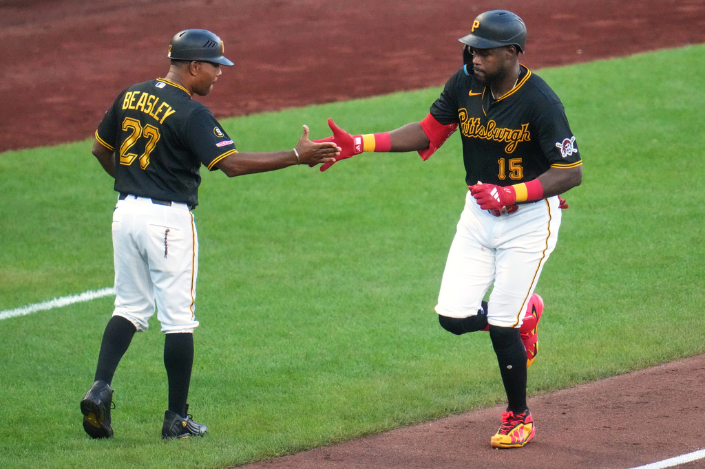 Pittsburgh Pirates' Oneil Cruz (15) is greeted by third base coach Tony Beasley (27) as he rounds third after hitting a two-run home run off Detroit Tigers pitcher Keider Montero during the fifth inning of a baseball game in Pittsburgh, Tuesday, Aug. 18, 2026. (AP Photo/Gene J. Puskar)
