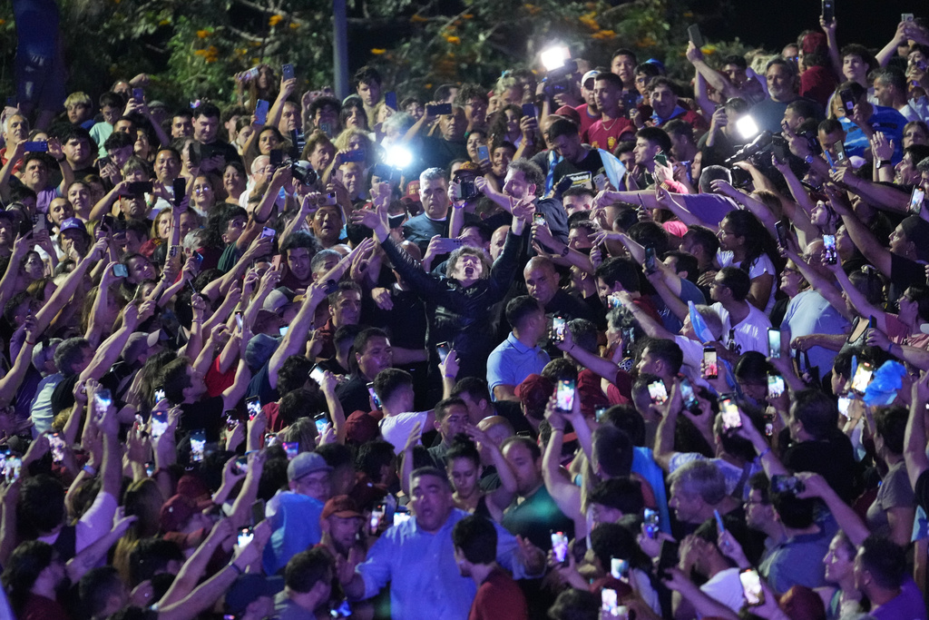 President Javier Milei joins the crowd during a rally in support of his party's candidates ahead of the upcoming midterm elections, in Rosario, Argentina, Thursday, Oct. 23, 2025. (AP Photo/Rodrigo Abd)