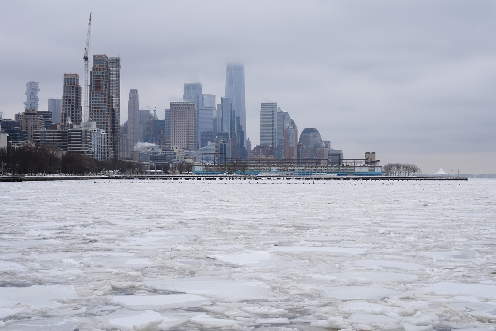 Clouds cover the top of One World Trade, top center, as ice crowds the Hudson River in New York, Monday, Jan. 26, 2026. (AP Photo/Seth Wenig)