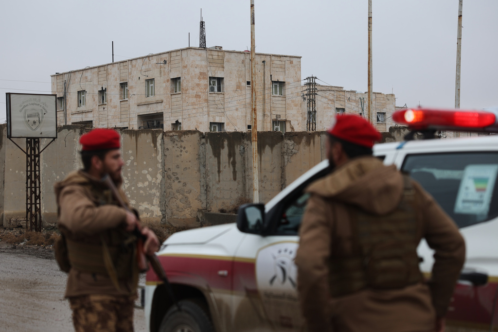 Syrian government forces stand guard at the al-Aqtan prison after taking control of it from the Kurdish-led Syrian Democratic Forces, SDF, in Raqqa, northeastern Syria, Friday, Jan. 23, 2026. (AP Photo/Ghaith Alsayed)
