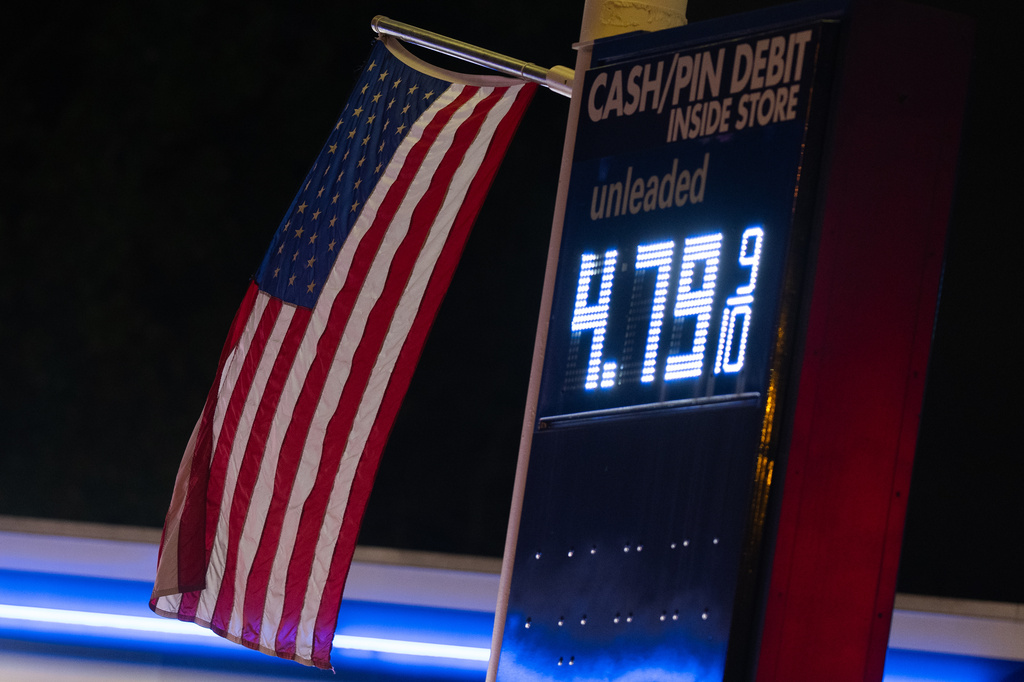 An American flag flies near a sign for fuel prices at a gas station on Wednesday, May 6, 2026, in Portland, Ore. (AP Photo/Jenny Kane)