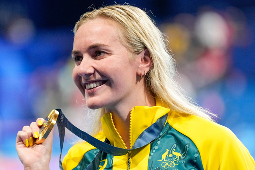 FILE - Australia's Ariarne Titmus poses with her gold medal after winning the women's 400-meter freestyle final at the 2024 Summer Olympics, Saturday, July 27, 2024, in Nanterre, France. (AP Photo/Ashley Landis,File) FILE - Australia's Ariarne Titmus poses with her gold medal after winning the women's 400-meter freestyle final at the 2024 Summer Olympics, Saturday, July 27, 2024, in Nanterre, France. (AP Photo/Ashley Landis,File)