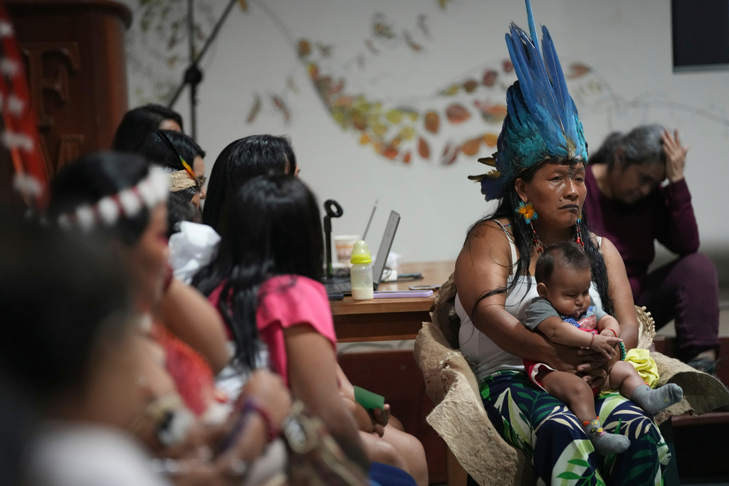A group of Indigenous women from across Ecuador's Amazon talk after what they call a toxitour where they visited oil fields in Nueva Loja, Ecuador, Friday, March 6, 2026. (AP Photo/Dolores Ochoa)