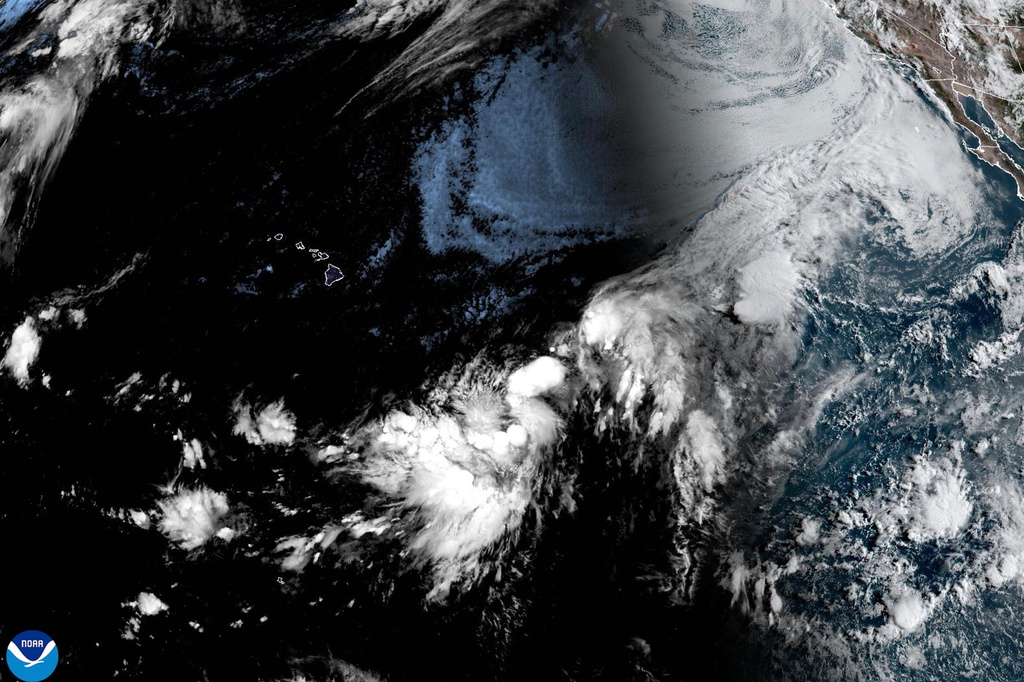 This NOAA satellite image taken at 11:38 a.m. EST on Wednesday, Aug. 12, 2026, shows a Potential Tropical Cyclone One-C, about 1,000-miles east-southeast of the Hawaiian Islands. (NOAA via AP)