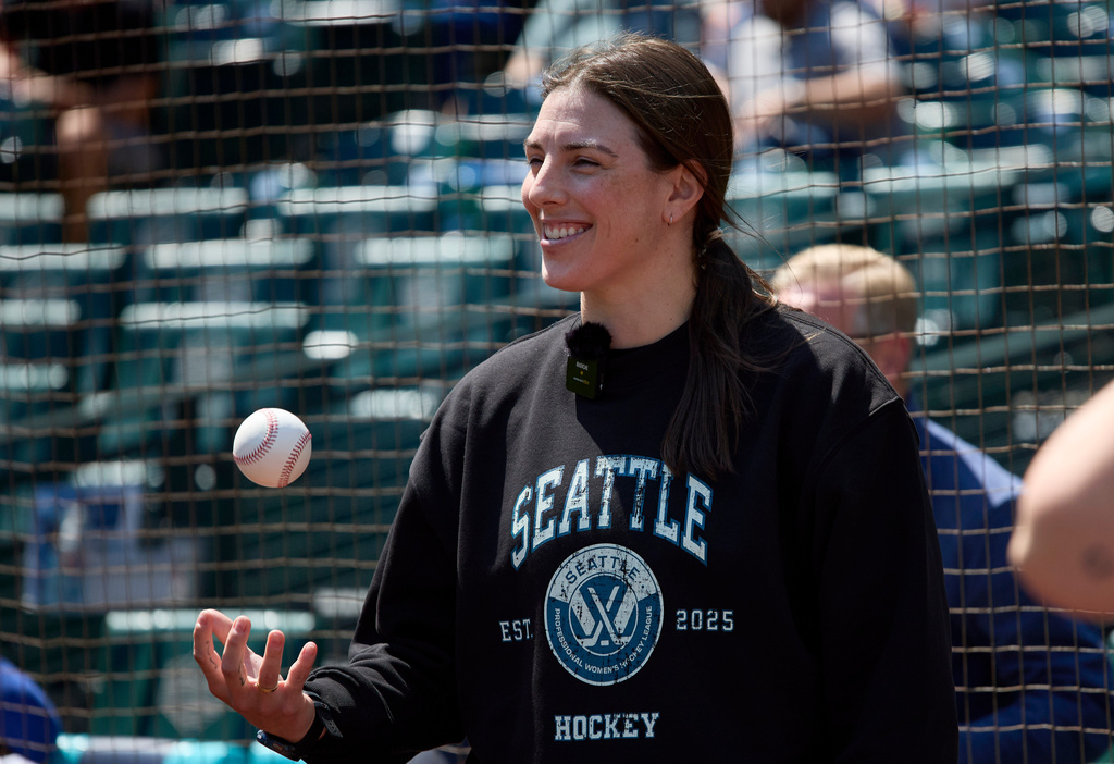FILE - PWHL Seattle forward Hilary Knight prepares to throw out the ceremonial first pitch before a baseball game between the Seattle Mariners and the Milwaukee Brewers, July 23, 2025, in Seattle. (AP Photo/John Froschauer, File)