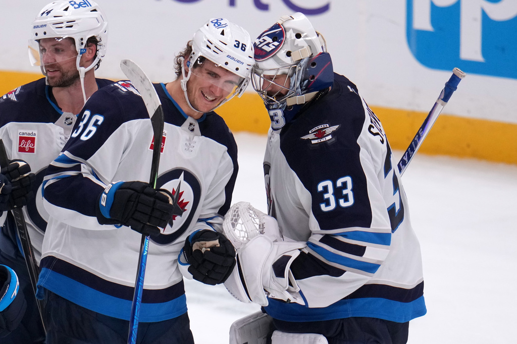 Winnipeg Jets goaltender Clay Stevenson (33) celebrates with Morgan Barron (36) at the end of an NHL hockey game against the Pittsburgh Penguins in Pittsburgh, Monday, Oct. 5, 2026. (AP Photo/Gene J. Puskar)