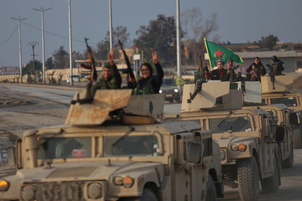 A convoy of Kurdish fighters with the Syrian Democratic Forces (SDF) flashes victory signs as it heads toward the front line ahead of the end of a four-day truce with the Syrian government in Hassakeh, northeastern Syria, Saturday, Jan. 24, 2026. (AP Photo/Baderkhan Ahmad)