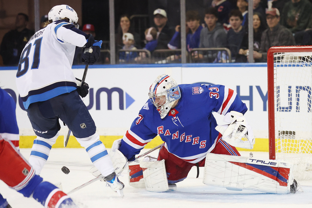 New York Rangers goaltender Dylan Garand (33) blocks a shot by Winnipeg Jets left wing Kyle Connor (81) during the second period of an NHL hockey game, Sunday, March 22, 2026, in New York. (AP Photo/Heather Khalifa)