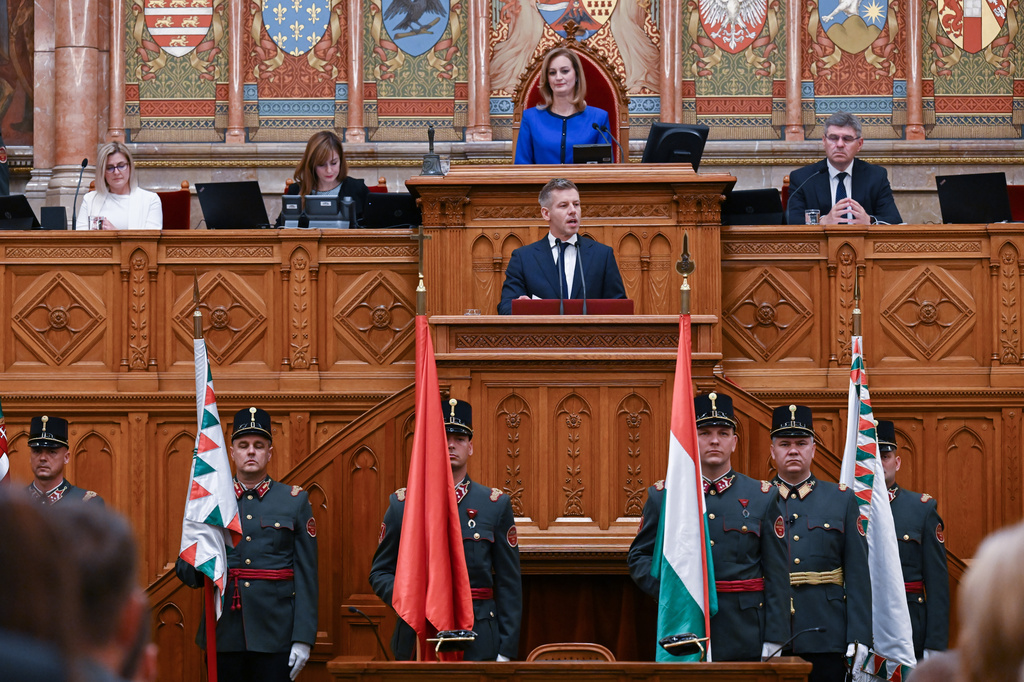 Hungary's Prime Minister Peter Magyar speaks in front of Speaker of the Parliament Agnes Forsthoffer during the plenary session of the new National Assembly following the appointment ceremony of the Tisza cabinet in Budapest, Hungary, Tuesday, May 12, 2026. (Tibor Illyes/MTI via AP)