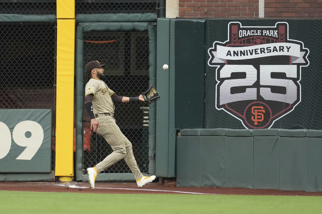 San Diego Padres right fielder Fernando Tatis Jr. catches a fly out in foul territory hit into by San Francisco Giants' Willy Adames during the first inning of a baseball game in San Francisco, Monday, Aug. 11, 2025. (AP Photo/Jeff Chiu)