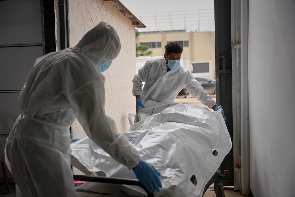 Bodies of unidentified Palestinians returned from Israel as part of the ceasefire deal are brought to Nasser Hospital in Khan Younis, Gaza Strip, Friday, Nov. 14, 2025. (AP Photo/Abdel Kareem Hana)