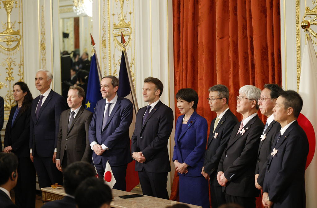 Japanese Prime Minister Sanae Takaichi, center right, and French President Emmanuel Macron, center left, pose for a group photo during signing ceremony at the Akasaka Palace state guest house in Tokyo Wednesday, April 1, 2026. (Franck Robichon/Pool Photo via AP)