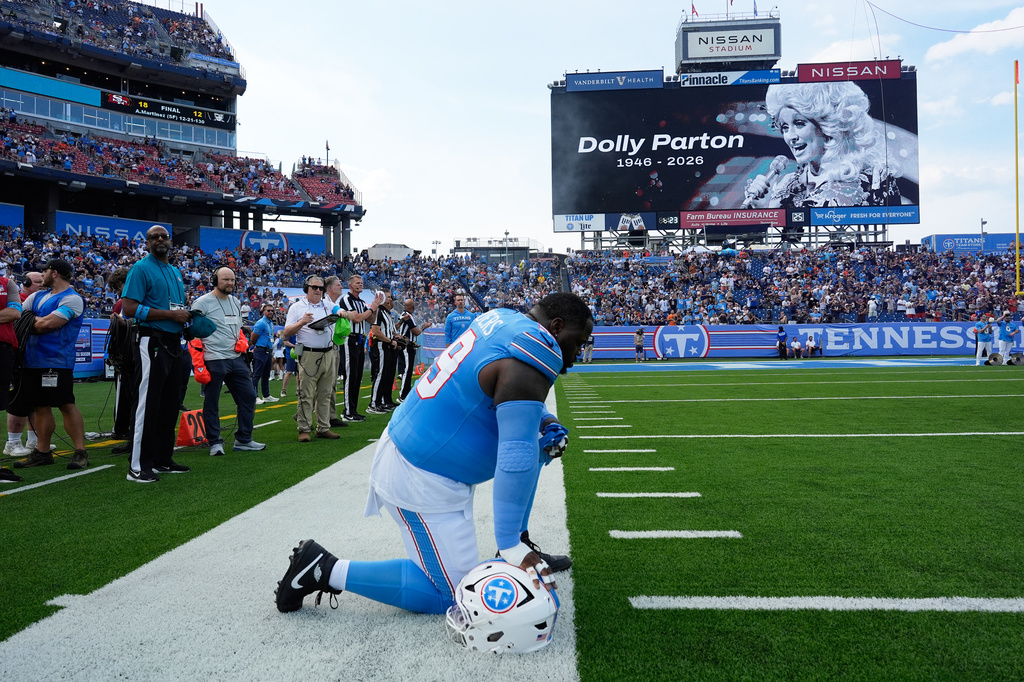 Tennessee Titans defensive tackle Khalen Saunders pauses during a moment of silence for Dolly Parton prior to a preseason NFL football game against the Chicago Bears, Saturday, Aug. 29, 2026, in Nashville, Tenn. (AP Photo/George Walker IV)