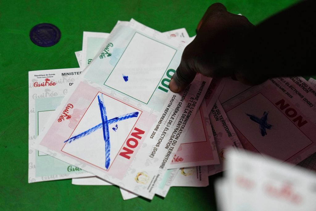 Officials count ballots at a polling station as polls close during the constitutional referendum in Conakry, Guinea, Sunday, Sept. 21, 2025. (AP Photo/Misper Apawu)