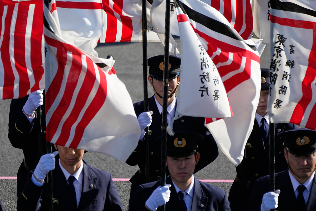 Members of the firefighter hold flags during the annual New Year's Fire Brigade Review Tuesday, Jan. 6, 2026, in Tokyo. (AP Photo/Eugene Hoshiko)