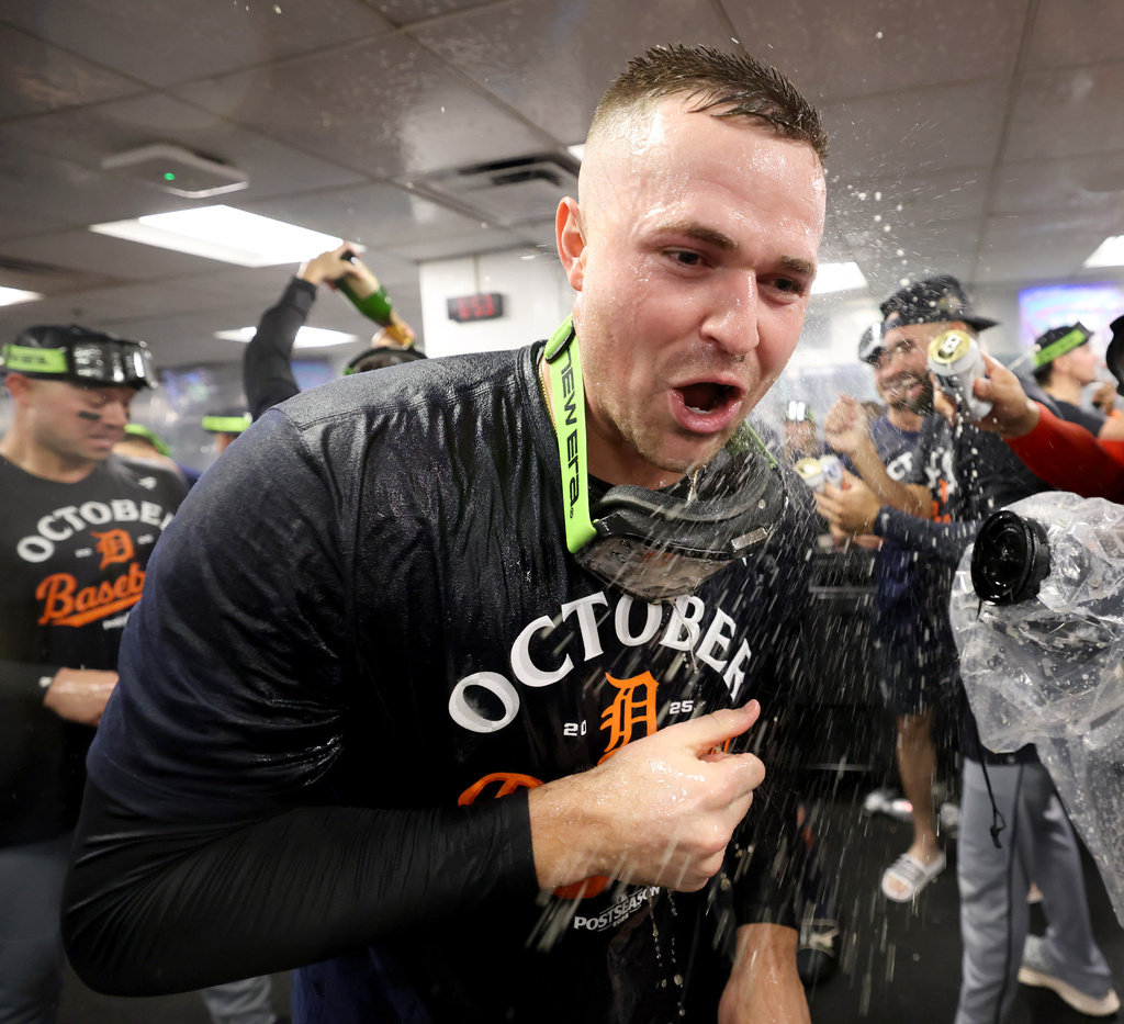 Detroit Tigers pitcher Tarik Skubal celebrates with teammates in the locker room after defeating the Boston Red Sox and clinching a spot in the playoffs, Saturday, Sept. 27, 2025, in Boston. (AP Photo/Mark Stockwell)