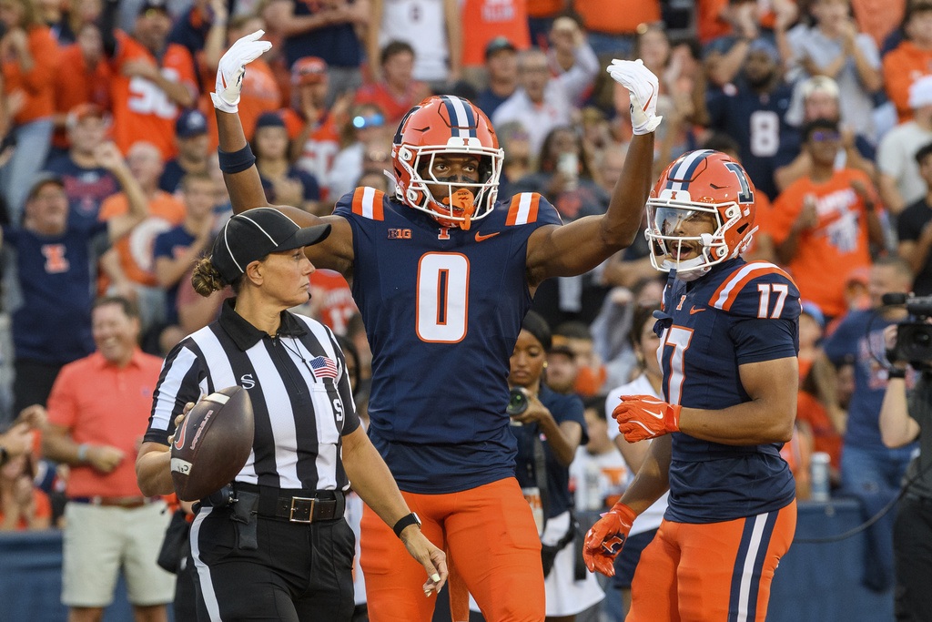 Illinois wide receiver Justin Bowick (0) celebrates a touchdown during the first half of an NCAA college football game against Western Illinois on Friday, Aug. 29, 2025, in Champaign, Ill. (AP Photo/Craig Pessman)