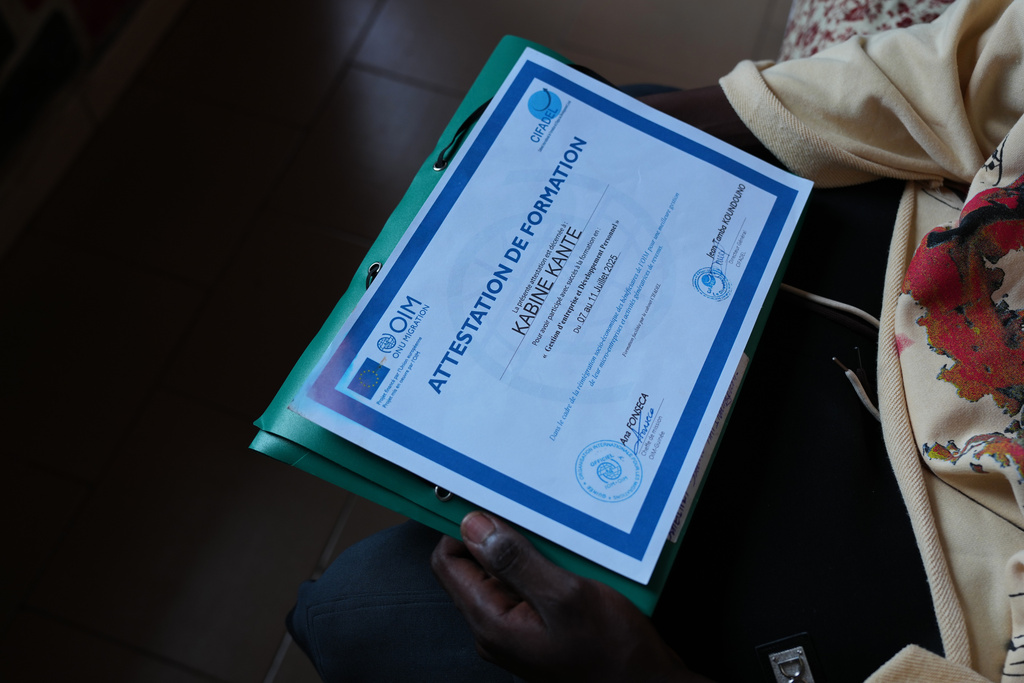 Kabinet Kante, a returnee, holds a training certificate issued by the International Organization for Migration (IOM) in Conakry, Guinea, Sept. 18, 2025. (AP Photo/Misper Apawu)