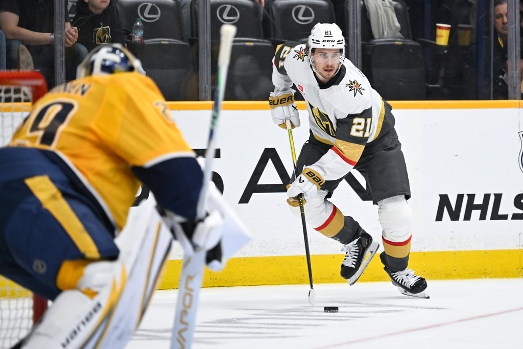 Vegas Golden Knights center Brett Howden (21) skates with the puck against the Nashville Predators during the first period of an NHL hockey game Saturday, March 21, 2026, in Nashville, Tenn. (AP Photo/John Amis)