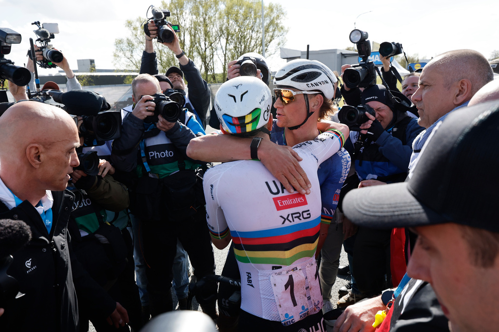 Slovenia's Tadej Pogacar is congratulated by Netherland's Mathieu Van Der Poel afternoon winning the Tour of Flanders cycling race, in Oudenaarde, Belgium Sunday, April 5, 2026. (AP Photo/Geert Vanden Wijngaert)