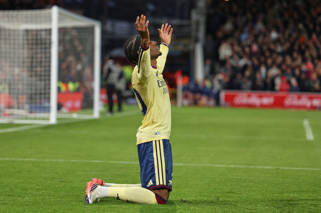 Arsenal's Noni Madueke celebrates after scoring his side's opening goal during the English Premier League soccer match between Nottingham Forest and Arsenal in Nottingham, England, Sunday, Oct. 18, 2026. (AP Photo/Maddy Grassy)