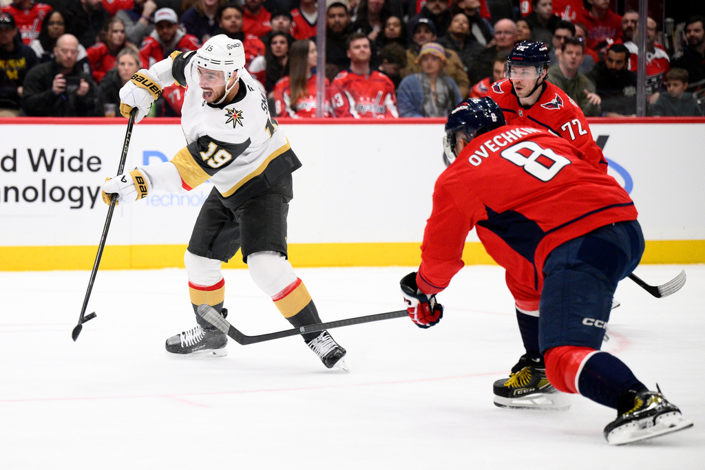 Vegas Golden Knights right wing Reilly Smith (19) shoots the puck past Washington Capitals left wing Alex Ovechkin (8) during the second period of an NHL hockey game, Friday, Feb. 27, 2026, in Washington. (AP Photo/Nick Wass)