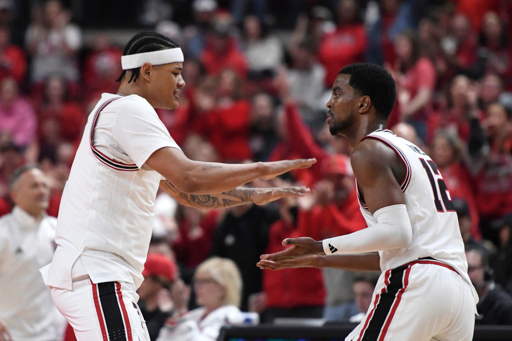 Texas Tech forward Lejuan Watts, left, high-fives Texas Tech forward Donovan Atwell after Atwell scored a 3-pointer during the first half in an NCAA college basketball game against Kansas State, Saturday, Feb. 21, 2026, in Lubbock, Texas. (AP Photo/Annie Rice)