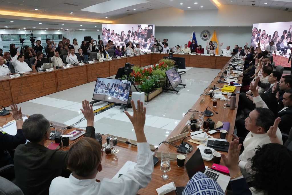 Members of Congress justice committee raise their hands as they vote during a congressional hearing on an impeachment bid against Vice President Sara Duterte at the House of Representatives in Quezon, Philippines Wednesday, April 29, 2026. (AP Photo/Aaron Favila)