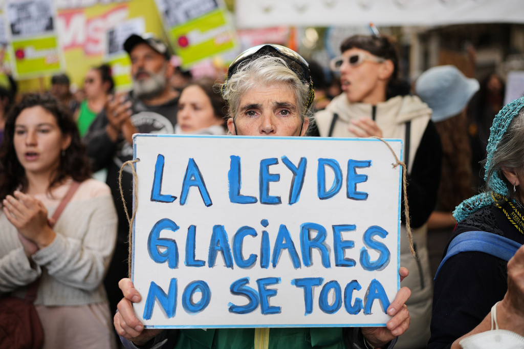 A demonstrator holds a banner that reads in Spanish, "The glacier law must not be touched," as lawmakers debate the Javier Milei government's proposal to reform the glacier protection law, outside Congress in Buenos Aires, Argentina, Wednesday, April 8, 2026. (AP Photo/Rodrigo Abd)