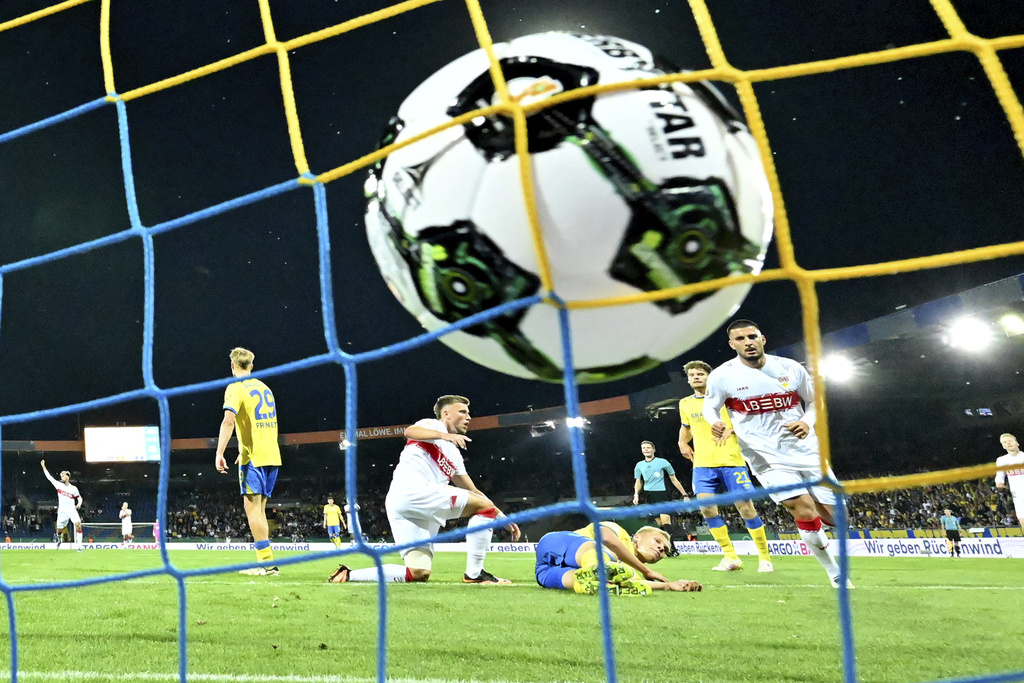 VfB Stuttgart's Ermedin Demirovi, center left, reacts after scoring a goal against Eintracht Braunschweig during a DFB Pokal, German Cup, soccer match, Tuesday, Aug. 26, 2205, in Brunswick, Germany. (Swen Pförtner/dpa via AP)