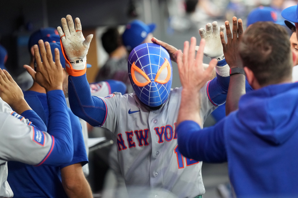 New York Mets' Francisco Lindor, center, celebrates with teammates in the dugout after his solo home during the seventh inning of a baseball game in Toronto, Monday, June 29, 2026. (Nathan Denette/The Canadian Press via AP)