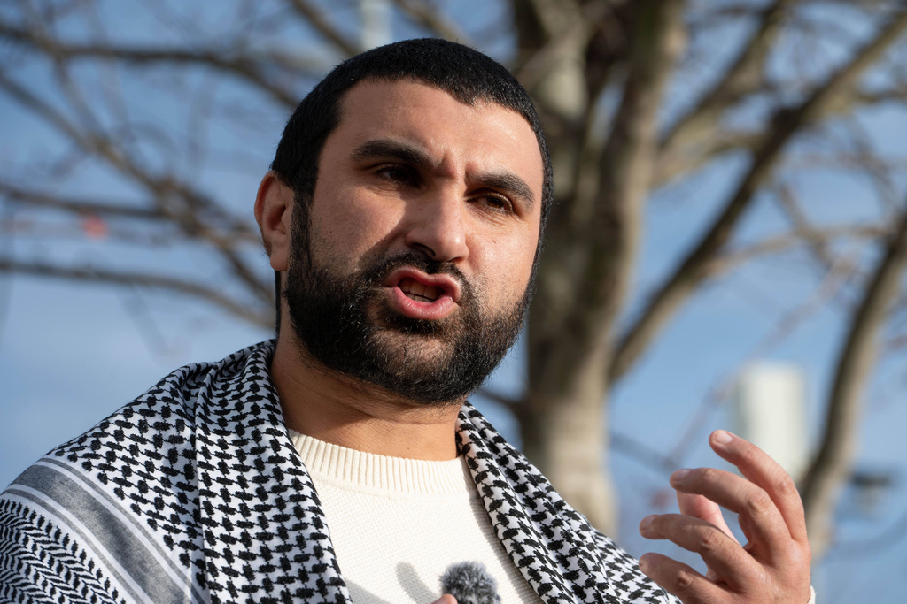 British political commentator Sami Hamdi speaks to the media in London, Thursday, Nov. 13, 2025, on his return to the U.K. after he was arrested by Immigration and Customs Enforcement on Oct. 26 while on a speaking tour in the U.S.. (AP Photo/Thomas Krych)