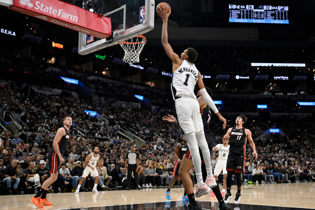 San Antonio Spurs center Victor Wembanyama (1) dunks during the second half of an NBA basketball game against the Miami Heat, Thursday, Oct. 30, 2025, in San Antonio. (AP Photo/Darren Abate)