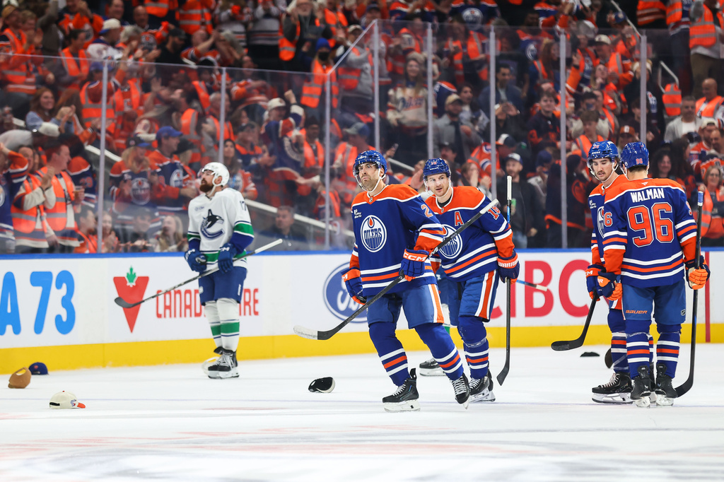 Edmonton Oilers' Evan Bouchard (2) celebrates his hat trick goal against the Vancouver Canucks during third period NHL hockey action in Edmonton on Tuesday, Sept. 29, 2026. (Codie McLachlan/The Canadian Press via AP)