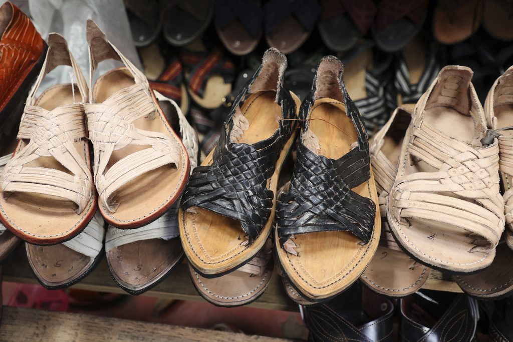 Sandals known as &quot;huaraches&quot; are displayed for sale at a market in Oaxaca, Mexico, Friday, Aug. 8, 2025. (AP Photo/Luis Alberto Cruz)