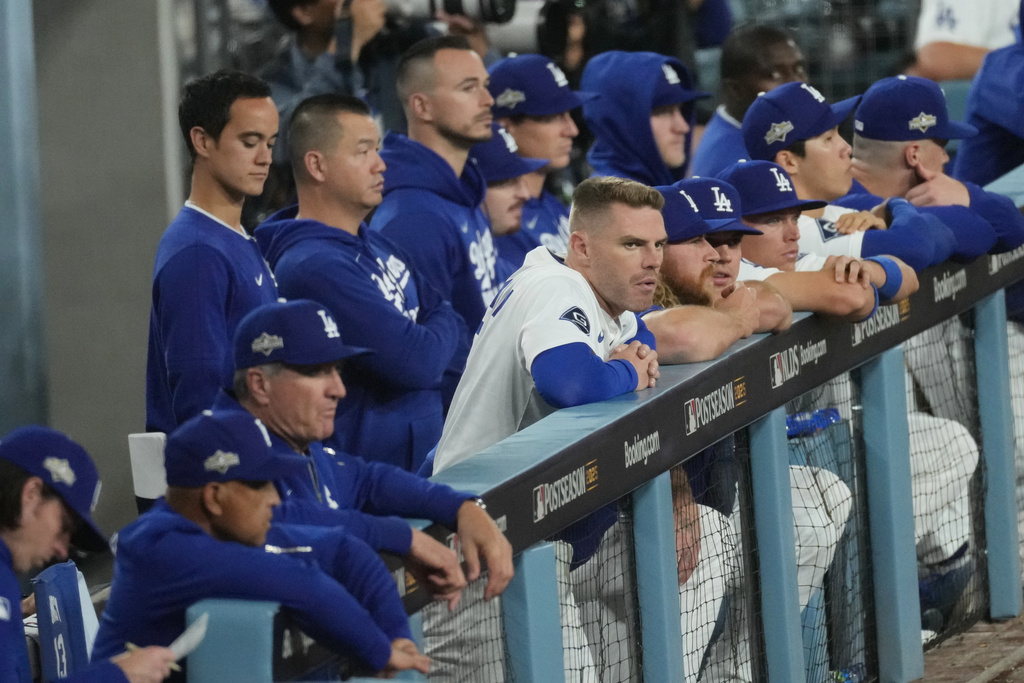 The Los Angeles Dodgers watch from the dugout during the ninth inning in Game 3 of baseball's National League Division Series against the Philadelphia Phillies, Wednesday, Oct. 8, 2025, in Los Angeles. (AP Photo/Jae C. Hong)