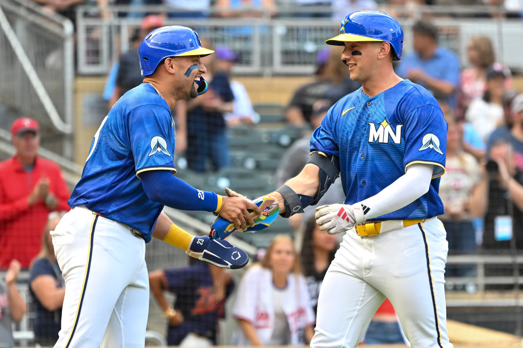 Minnesota Twins' Brooks Lee, right, celebrates with Royce Lewis, left, after hitting a two-run home run which also scored Lewis during the second inning of a baseball game against the Colorado Rockies, Friday, June 26 2026, in Minneapolis. (AP Photo/Craig Lassig)