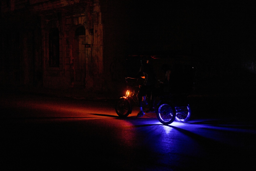 A vehicle drives down a street during a blackout in Havana, Wednesday, March 4, 2026. (AP Photo/Ramon Espinosa)