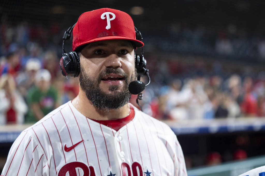 Philadelphia Phillies' Kyle Schwarber, looks on after getting doused with water as he is giving a post game interview following a baseball game against the New York Mets, Tuesday, Sep. 9, 2025, in Philadelphia. (AP Photo/Chris Szagola)